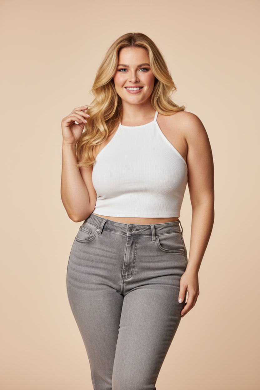 Woman wearing a white halter top with text highlighting the outfit's features.